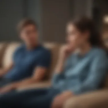 A couple sitting apart on a couch, reflecting a sense of distance