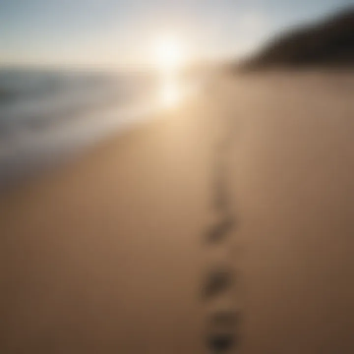 A tranquil beach scene with footprints leading into the distance