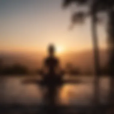 Silhouette of person meditating at sunrise