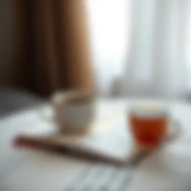A journal and a cup of tea, symbolizing introspection