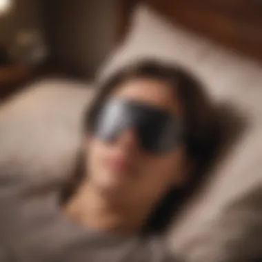 An individual peacefully sleeping with a sleep mask and mobile device nearby.